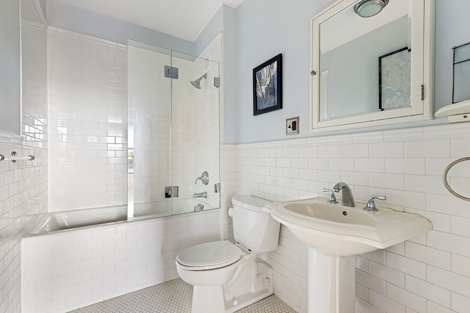 1 Tiffany Place, Unit 4B Brooklyn, NY 11231 - Photo 5 of 6 a bathroom with a sink toilet a mirror and shower