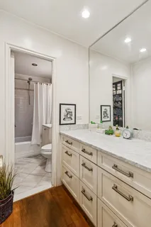 a spacious bathroom with a granite countertop sink and a mirror