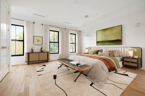 a bedroom with a bed and glass windows