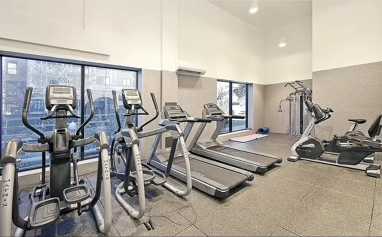 424 Bedford Avenue, Unit 5C Brooklyn, NY 11249 - Photo 10 of 11 a room with gym equipment and large mirror