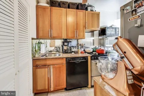 a kitchen with a sink cabinets and window