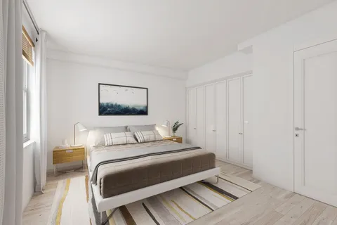 a bedroom with a bed and a painting on the wall