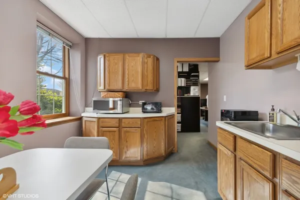 a kitchen with granite countertop a sink stove and cabinets
