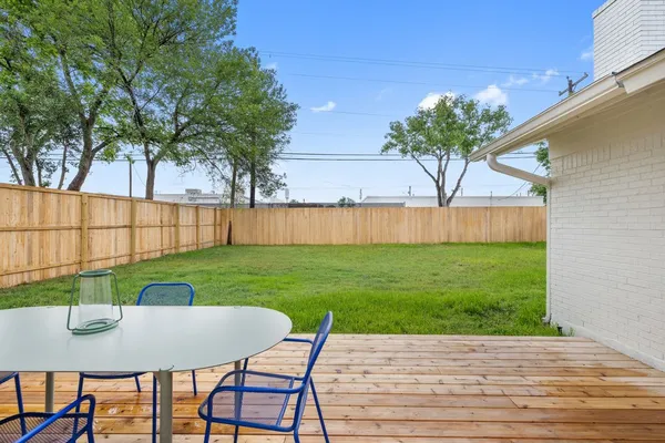 a view of a table and chairs in patio of the house