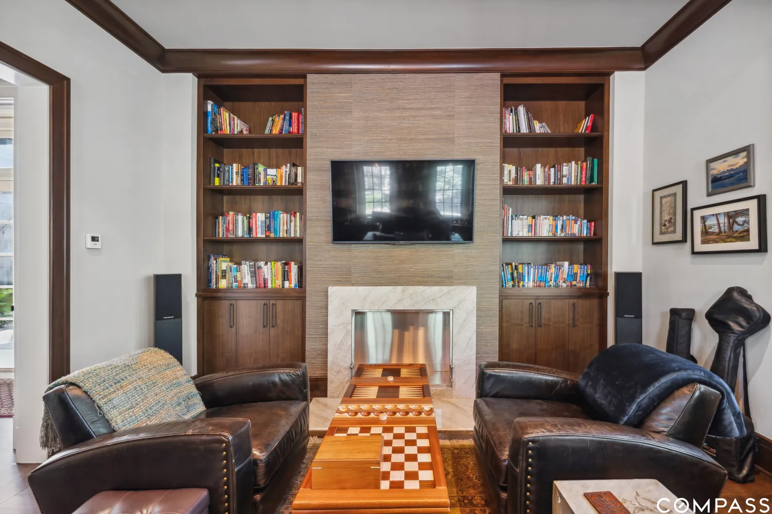 a living room with furniture a flat screen tv and a fireplace