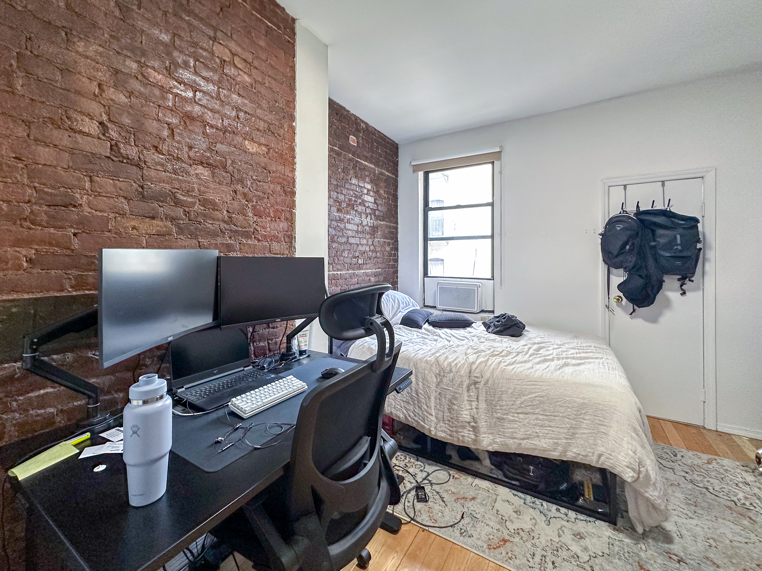 213 East 5th Street, Unit 5 Manhattan, NY 10003 - Photo 11 of 17 a bedroom with a bed and wooden floor