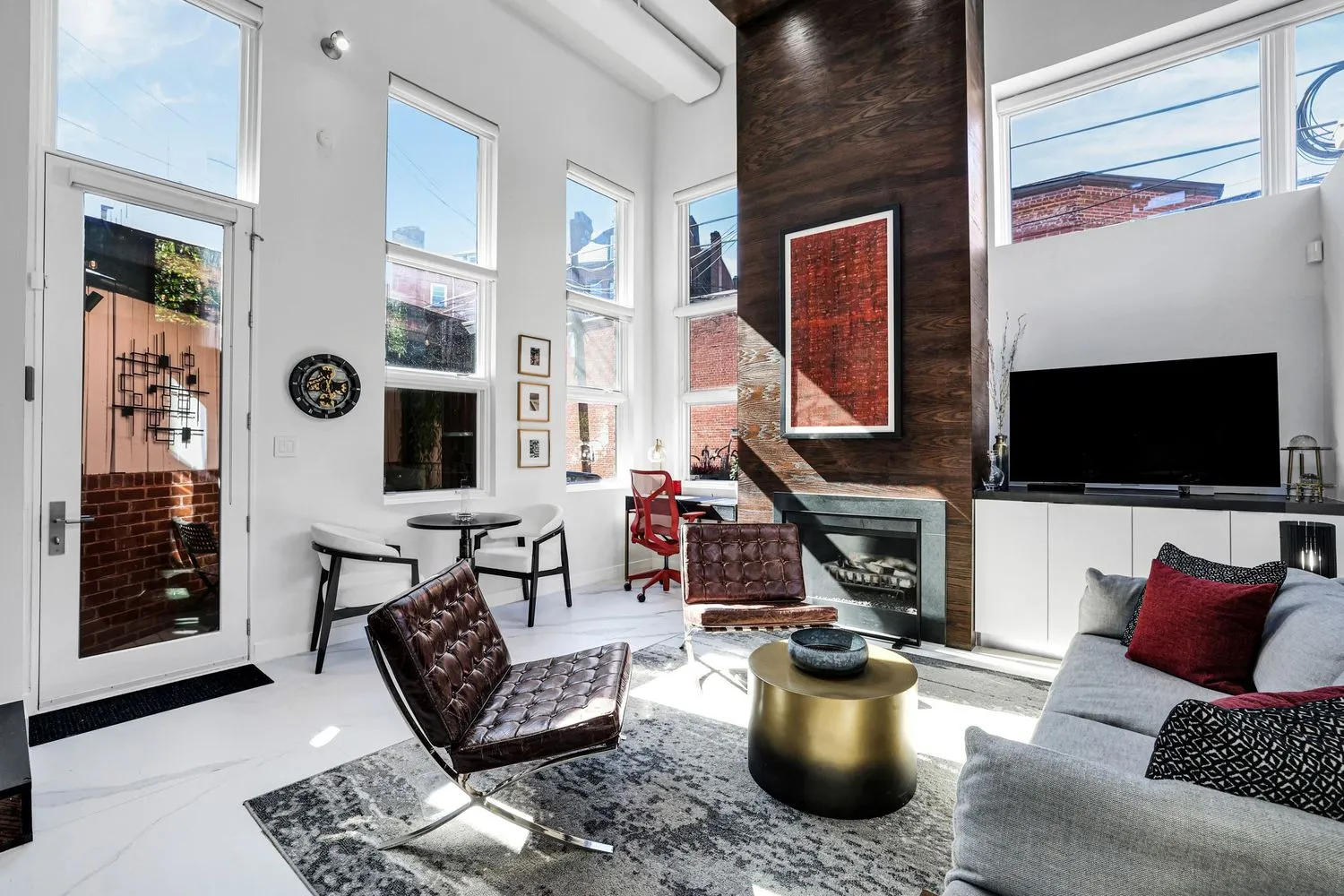 a living room with furniture a flat screen tv and a fireplace