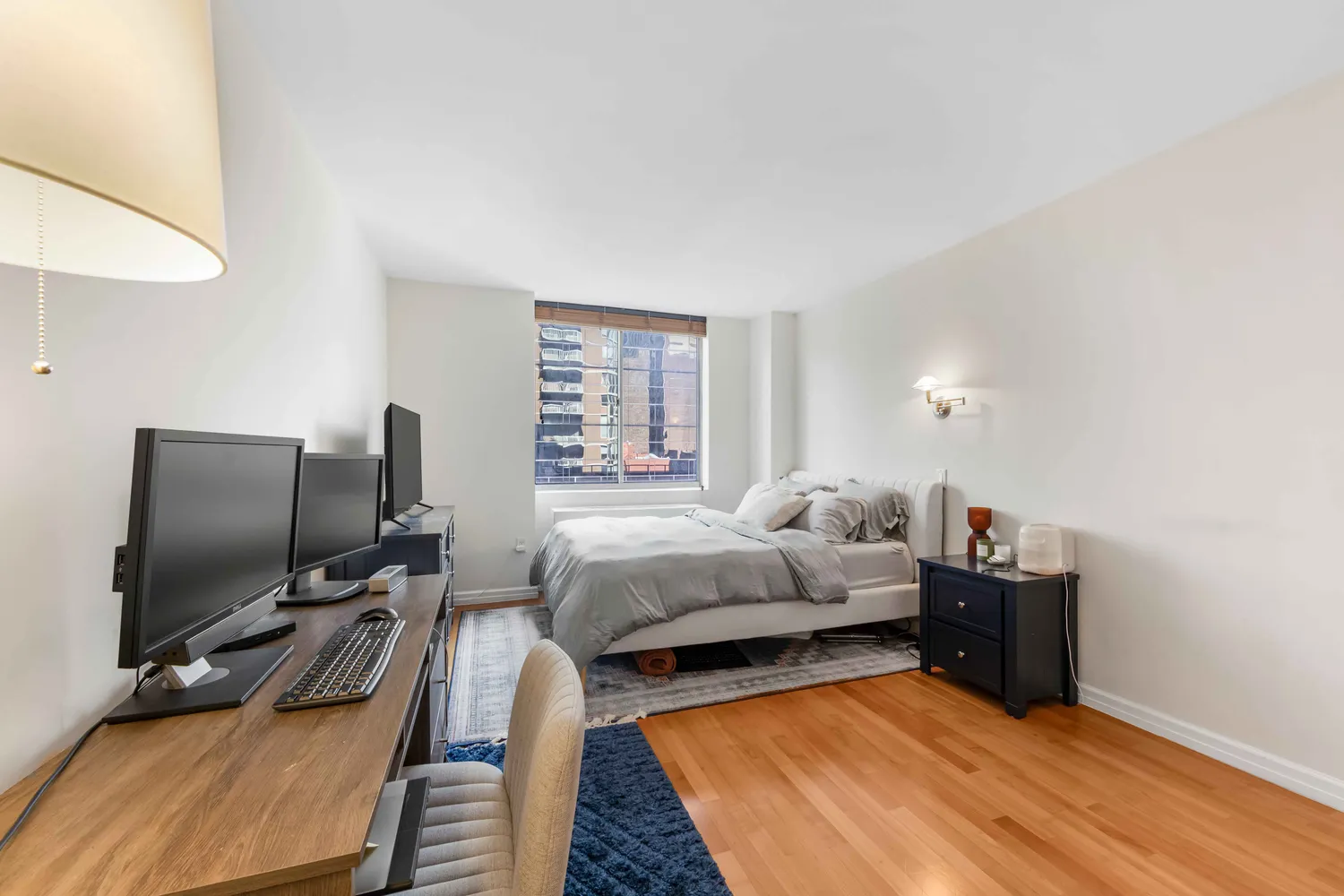 a bedroom with furniture and a flat screen tv