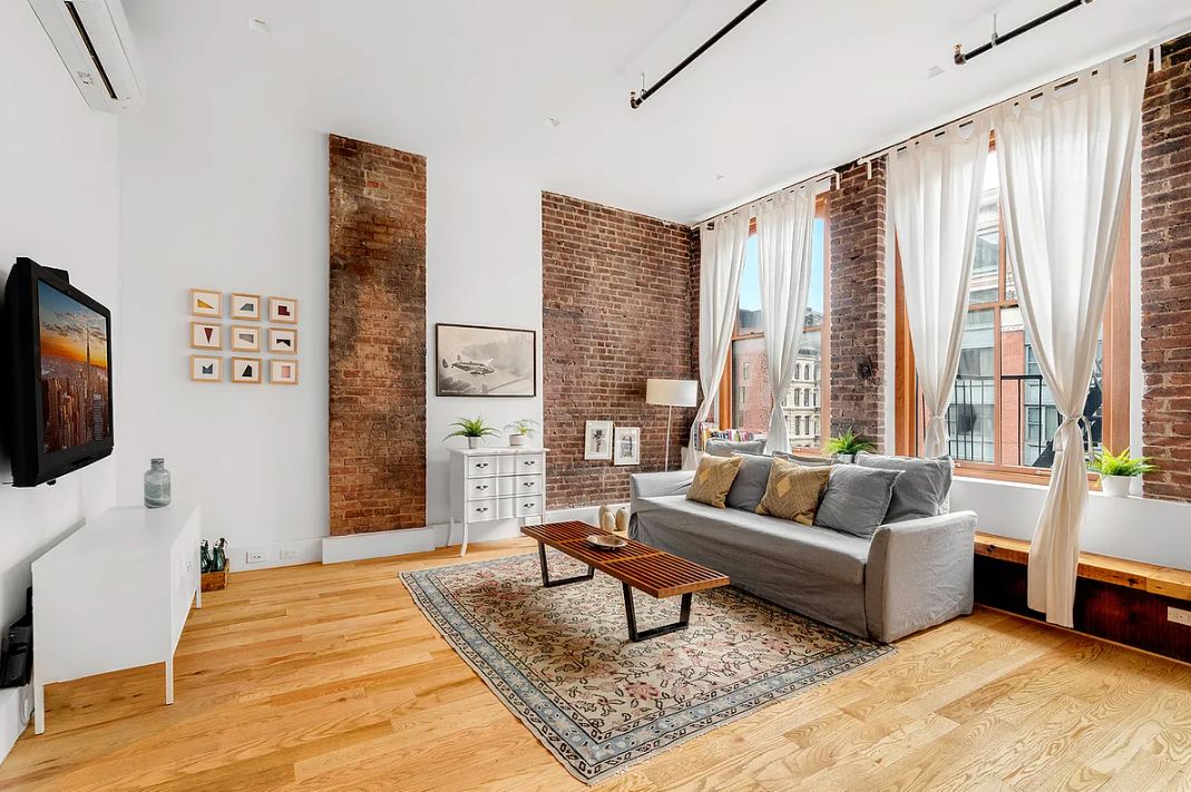 293 Church Street, Unit 5 Manhattan, NY 10013 - Photo 2 of 8 a living room with furniture and a flat screen tv