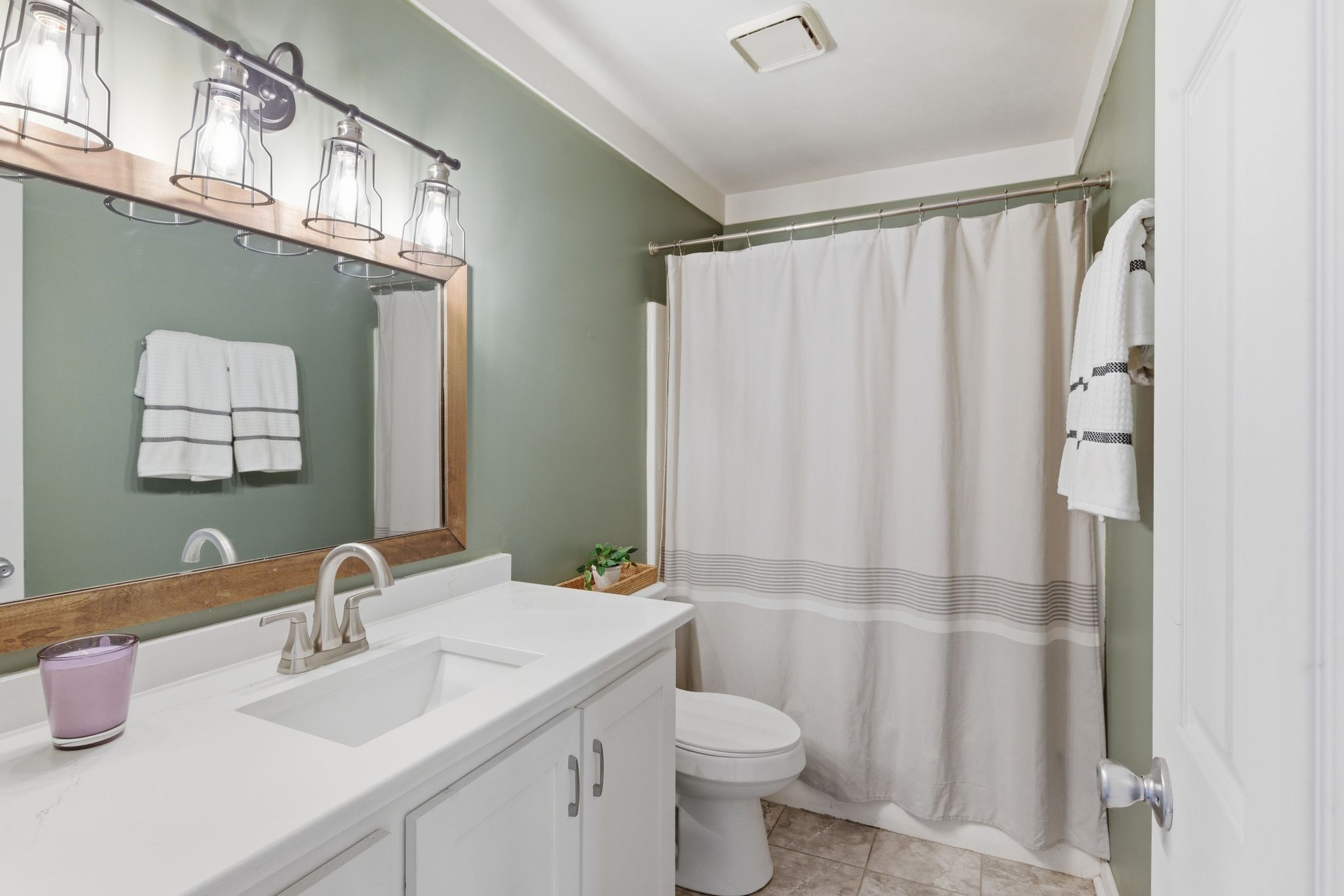 307 Paragon Mills Road Nashville, TN 37211 - Photo 23 of 29 a bathroom with a sink a toilet and shower curtain