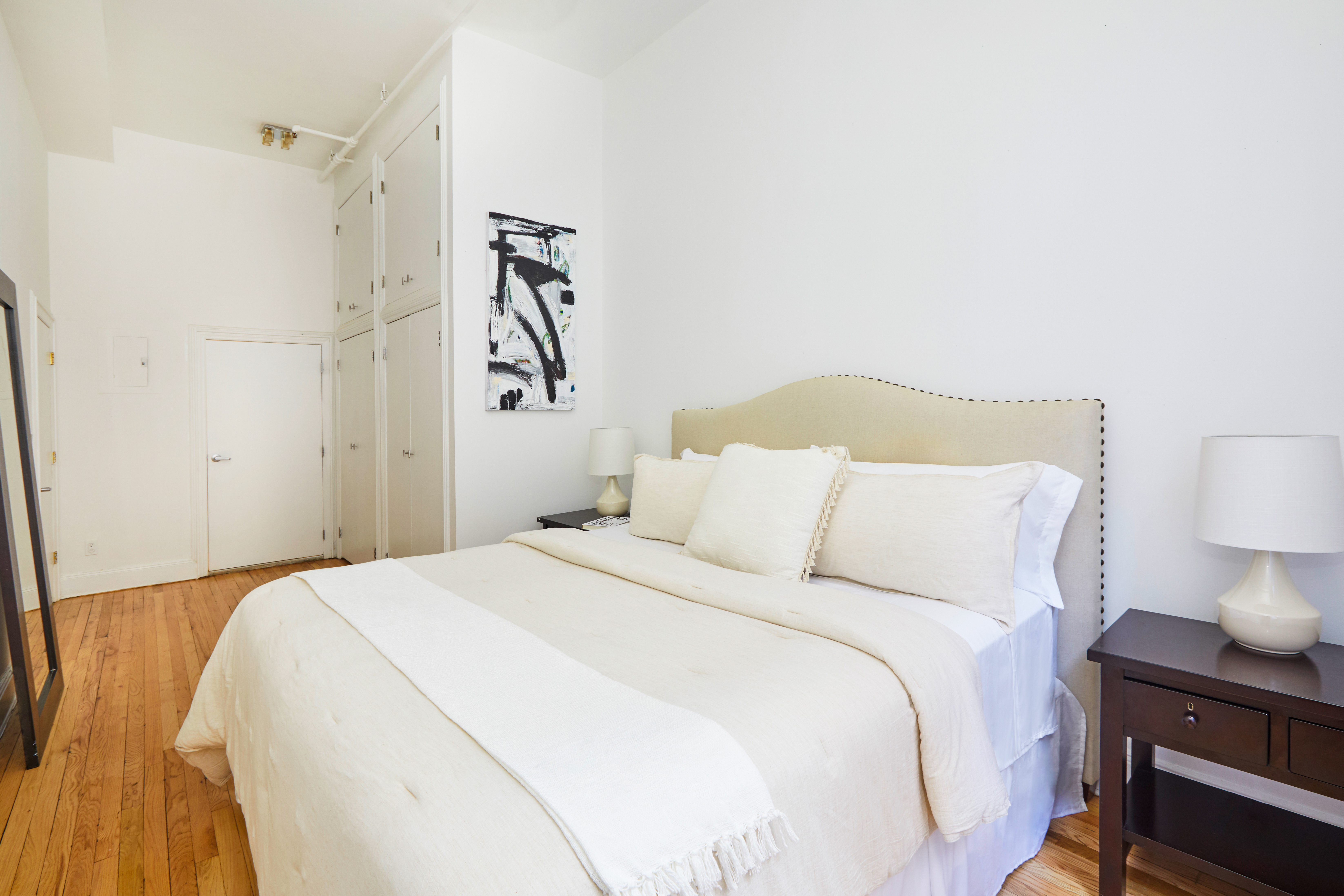 80 Leonard Street, Unit 3G Manhattan, NY 10013 - Photo 18 of 30 a bedroom with a bed and a night stand