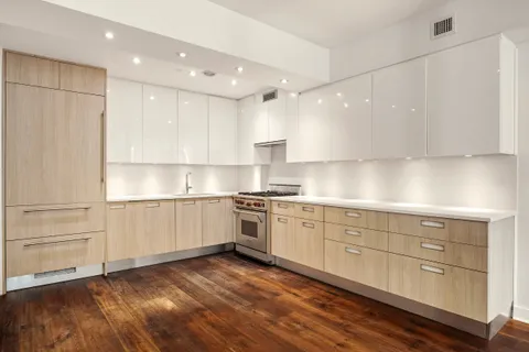 a kitchen with granite countertop white cabinets and white appliances