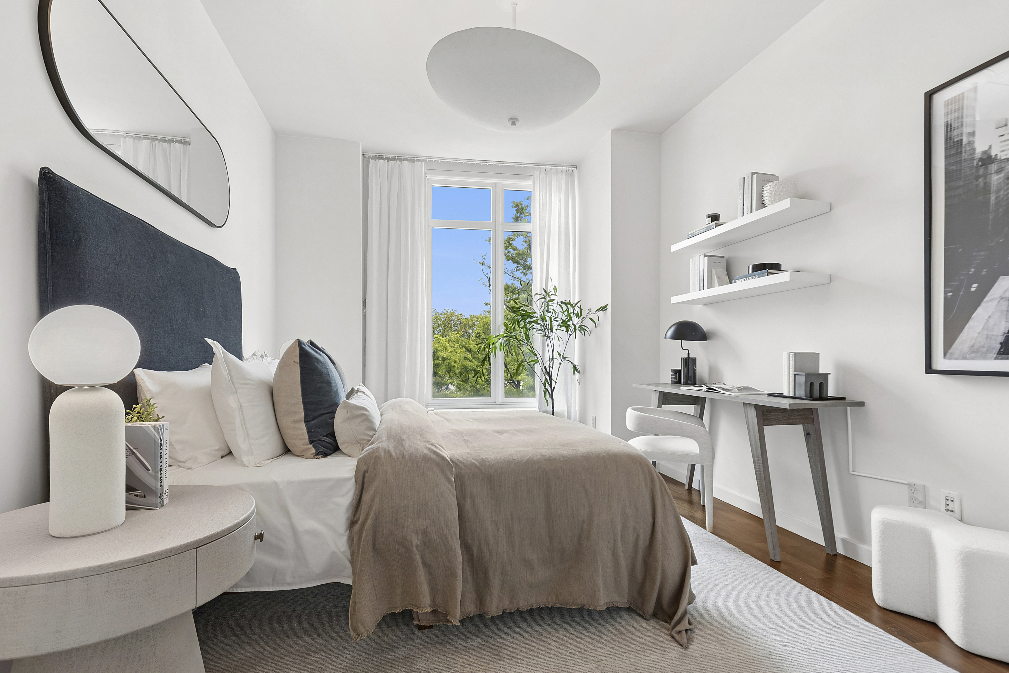 400 West 12th Street, Unit 3E Manhattan, NY 10014 - Photo 8 of 11 a bedroom with furniture and a large window