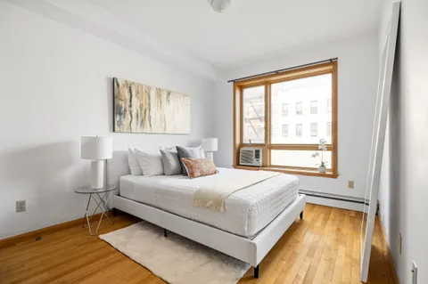 a bedroom with a bed and a window