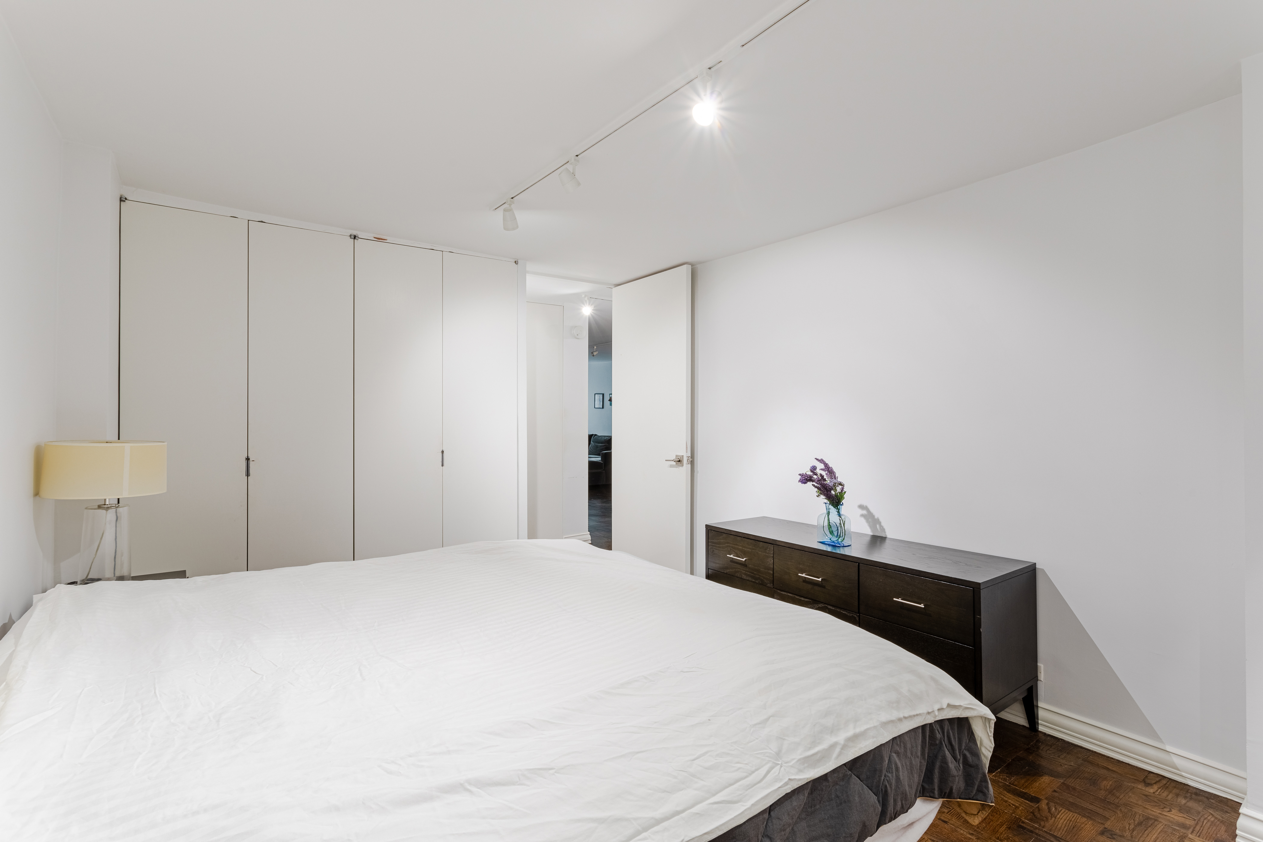155 East 38th Street, Unit 10D Manhattan, NY 10016 - Photo 8 of 15 a bedroom with a bed and a night stand