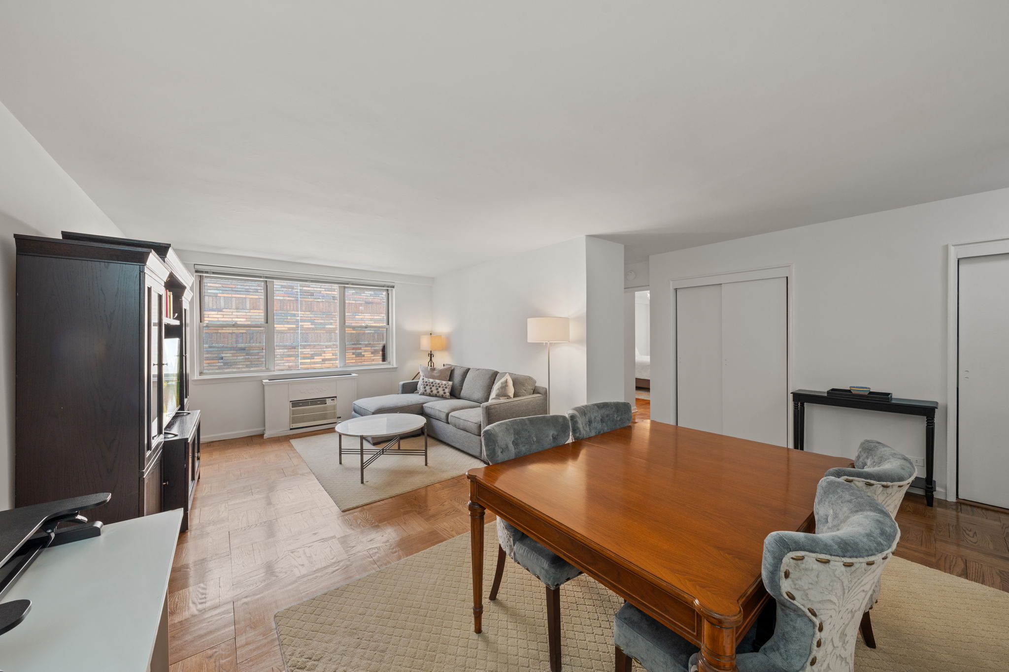a living room with furniture pool table and stainless steel appliances