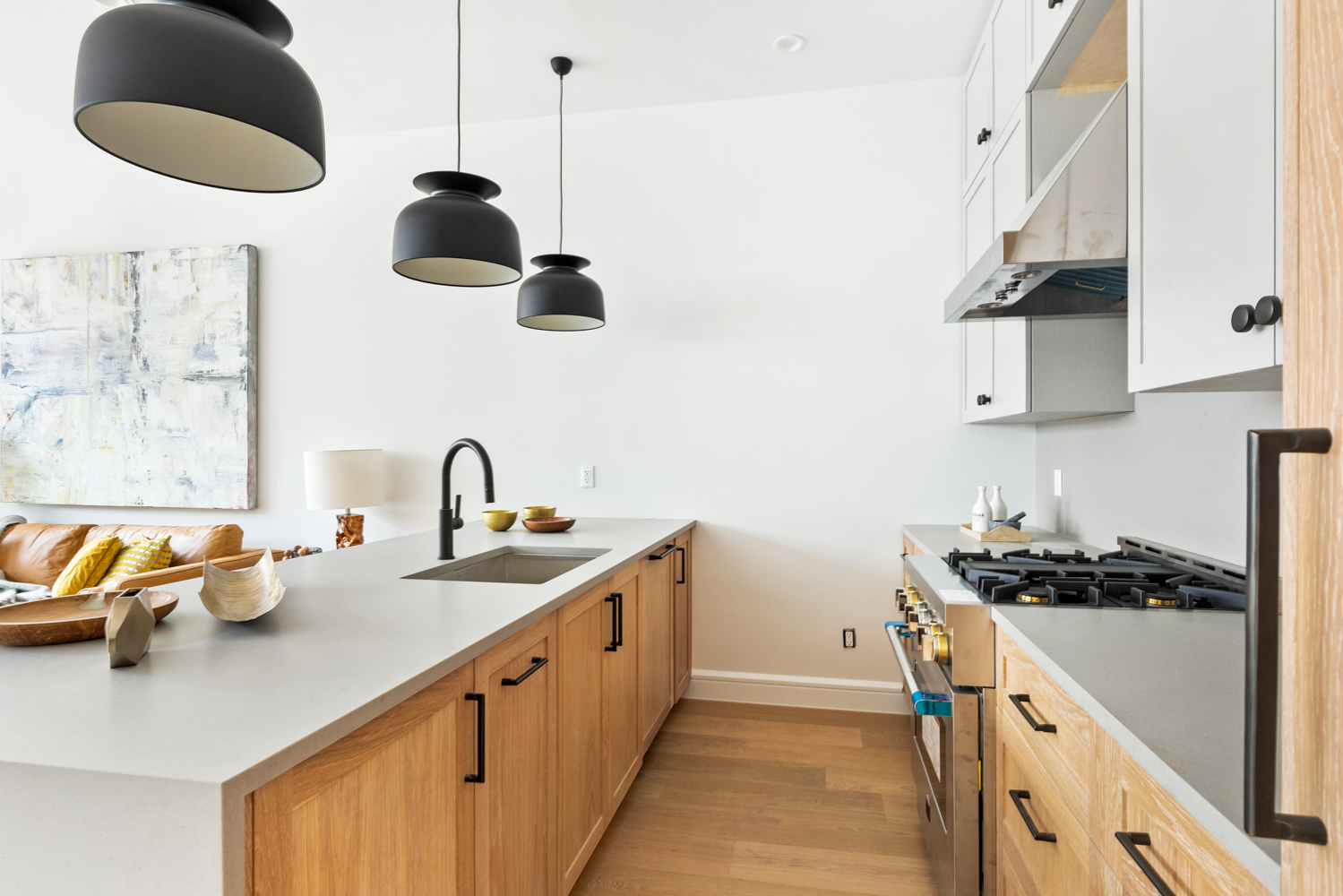 243 North 5th Street, Unit 2B Brooklyn, NY 11211 - Photo 7 of 14 a kitchen with stainless steel appliances granite countertop a sink a stove and a wooden floors
