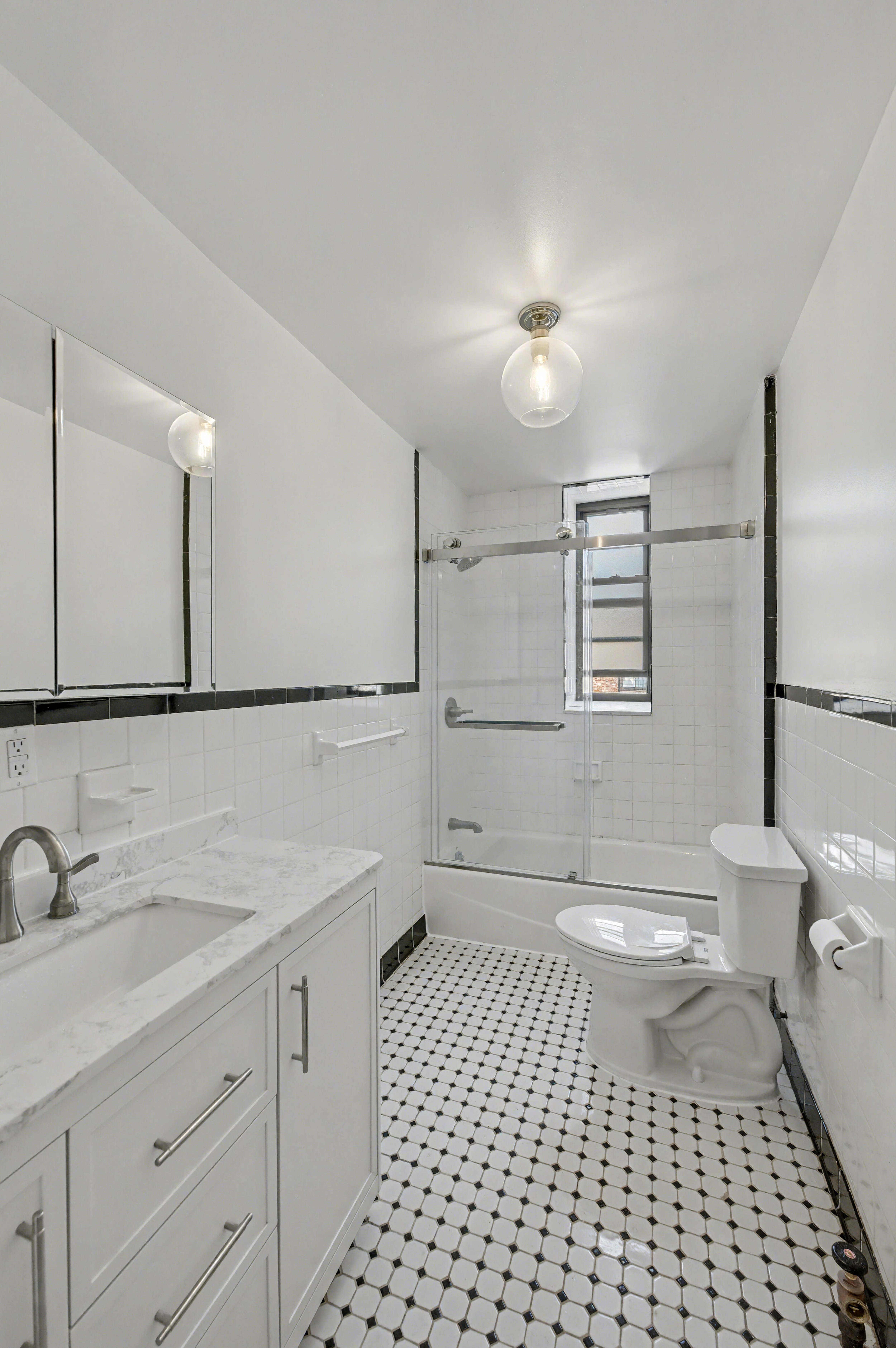 261 Clinton Street, Unit 3 Brooklyn, NY 11201 - Photo 11 of 12 a bathroom with a sink a toilet a mirror and shower