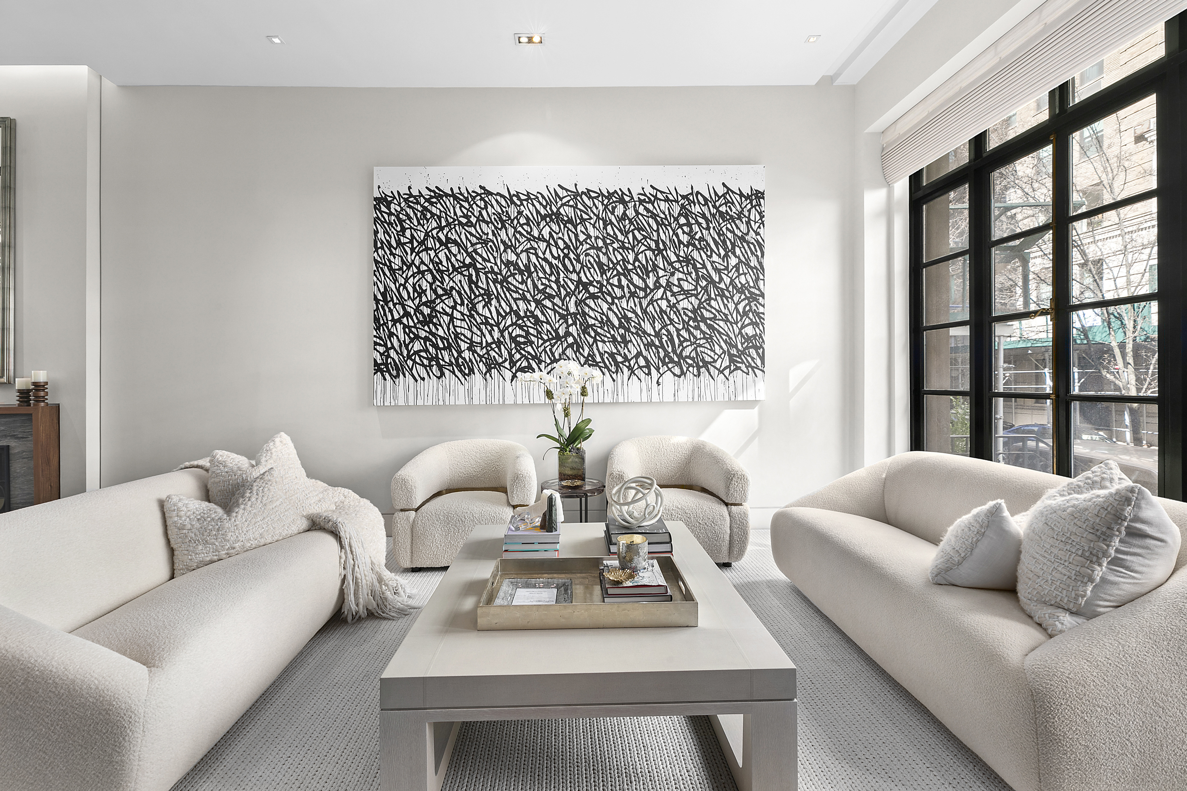36 East 64th Street Manhattan, NY 10065 - Photo 2 of 27 a living room with furniture and a large window