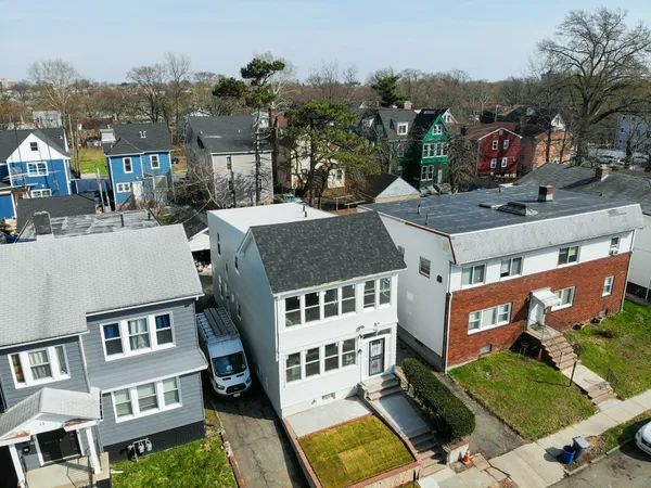 a aerial view of a residential apartment building with a yard