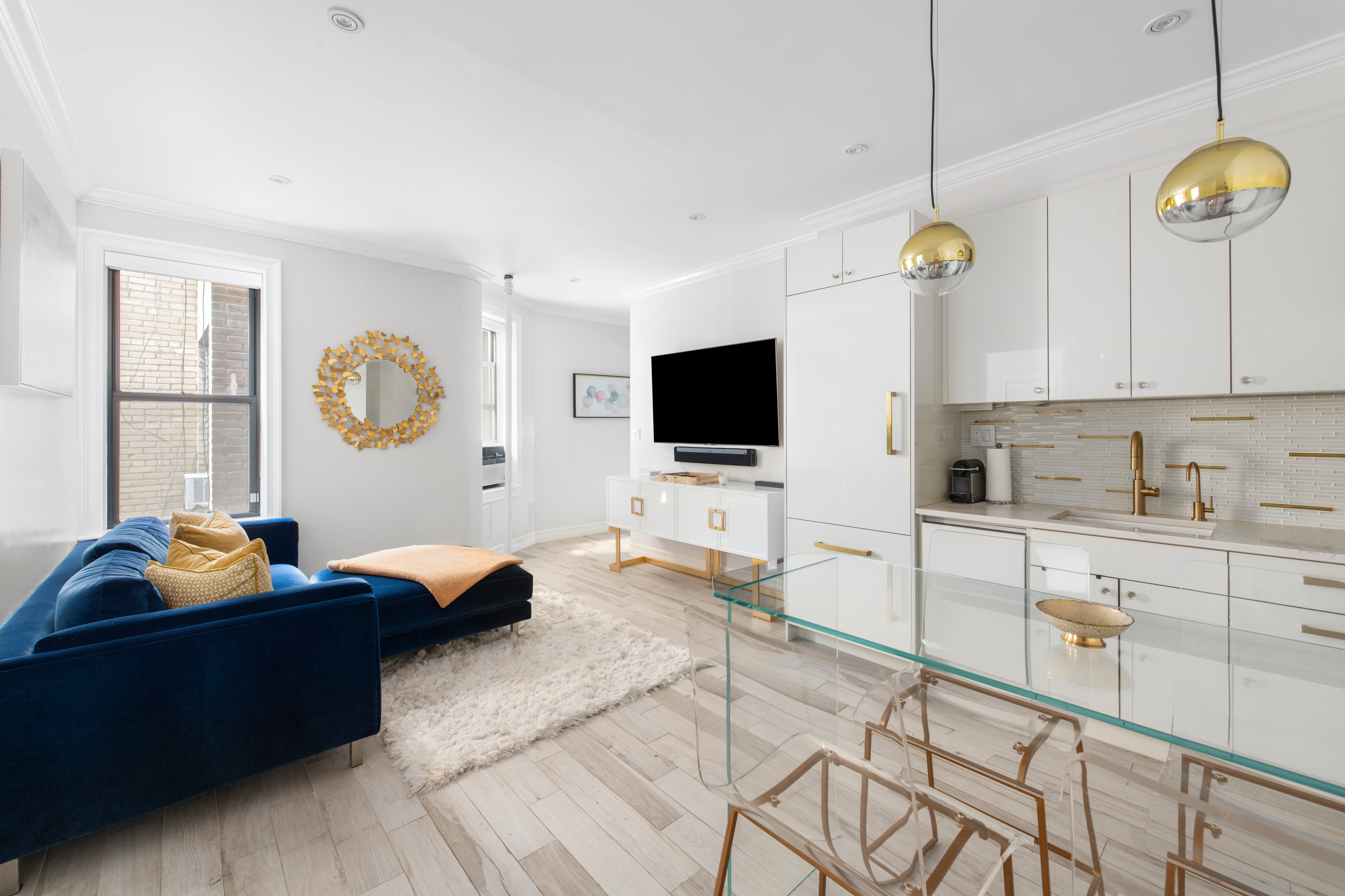 135 Ridge Street, Unit 5A Manhattan, NY 10002 - Photo 3 of 11 a living room with furniture and a flat screen tv