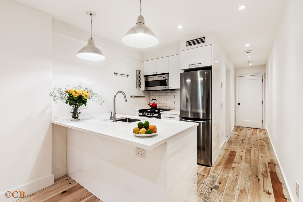 a kitchen with a refrigerator and a sink