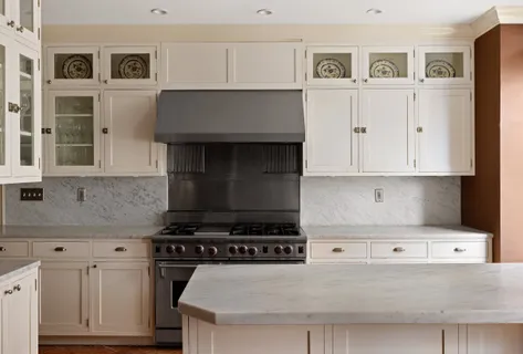 a kitchen with granite countertop a stove oven and white cabinets