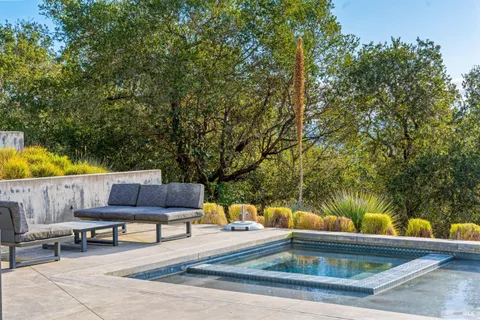 a swimming pool with outdoor seating and yard