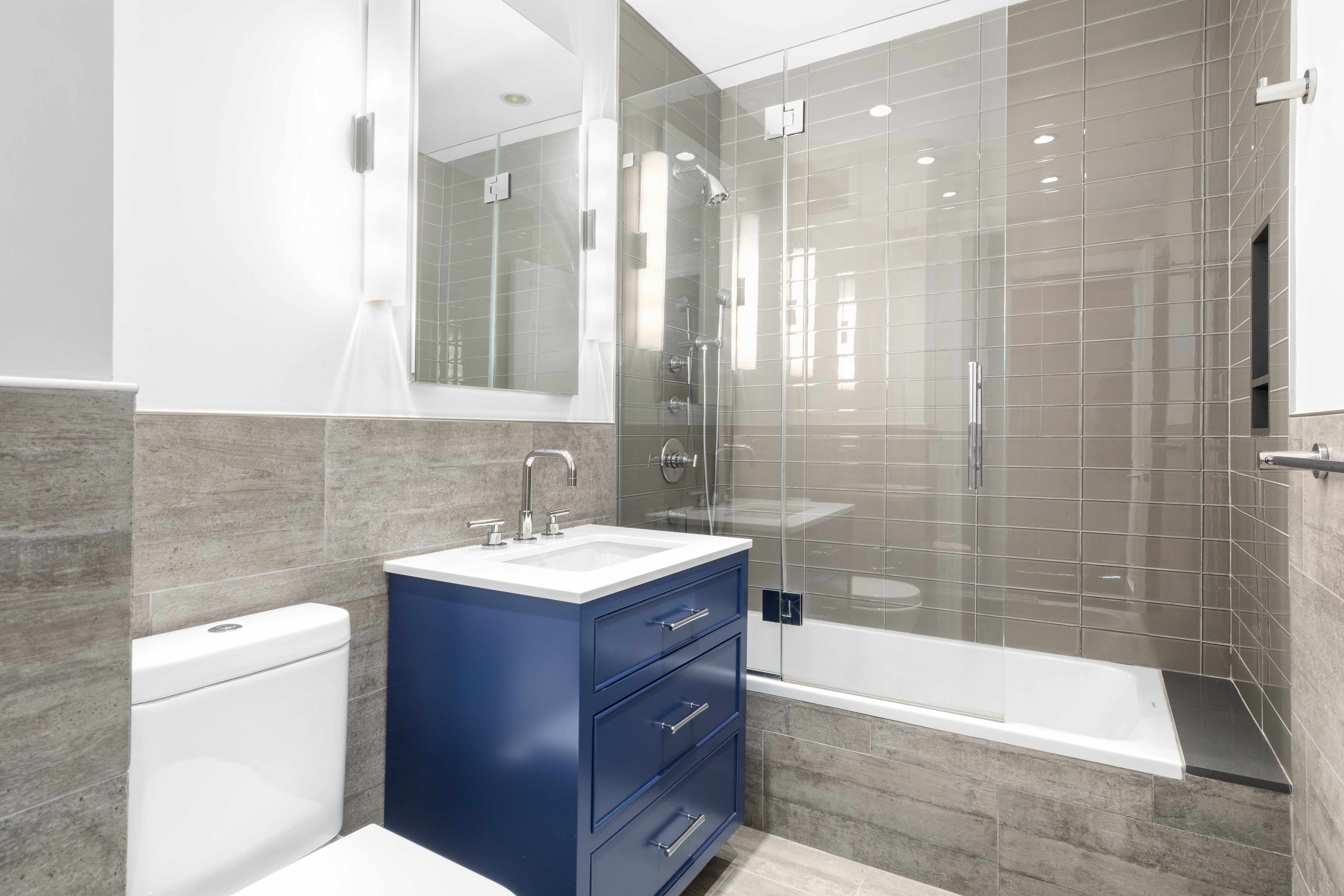 360 East 88th Street, Unit 20D Manhattan, NY 10128 - Photo 8 of 15 a bathroom with a sink toilet tub and shower