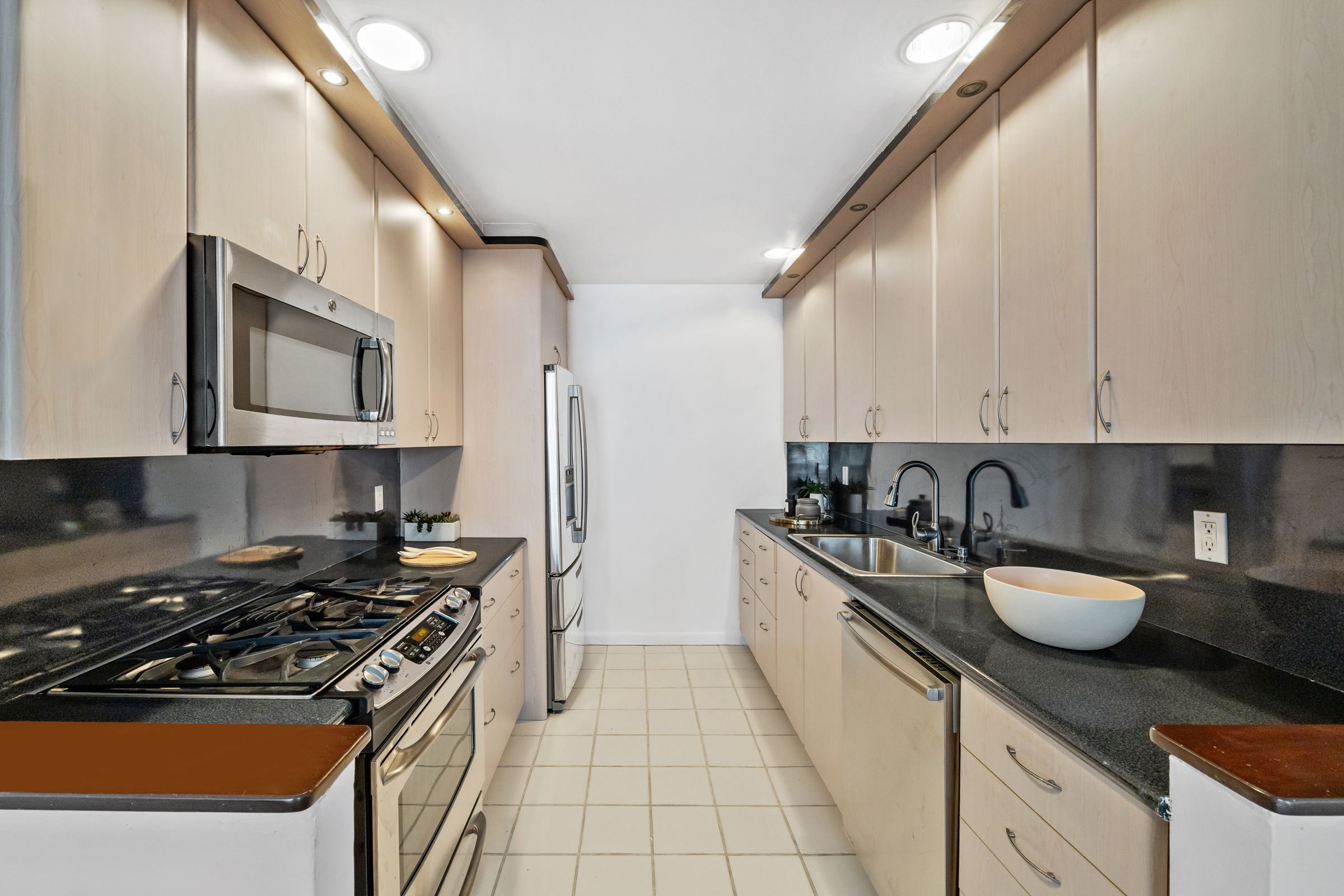 196 6th Avenue, Unit 5A Manhattan, NY 10013 - Photo 4 of 12 a kitchen with a sink a stove and cabinets