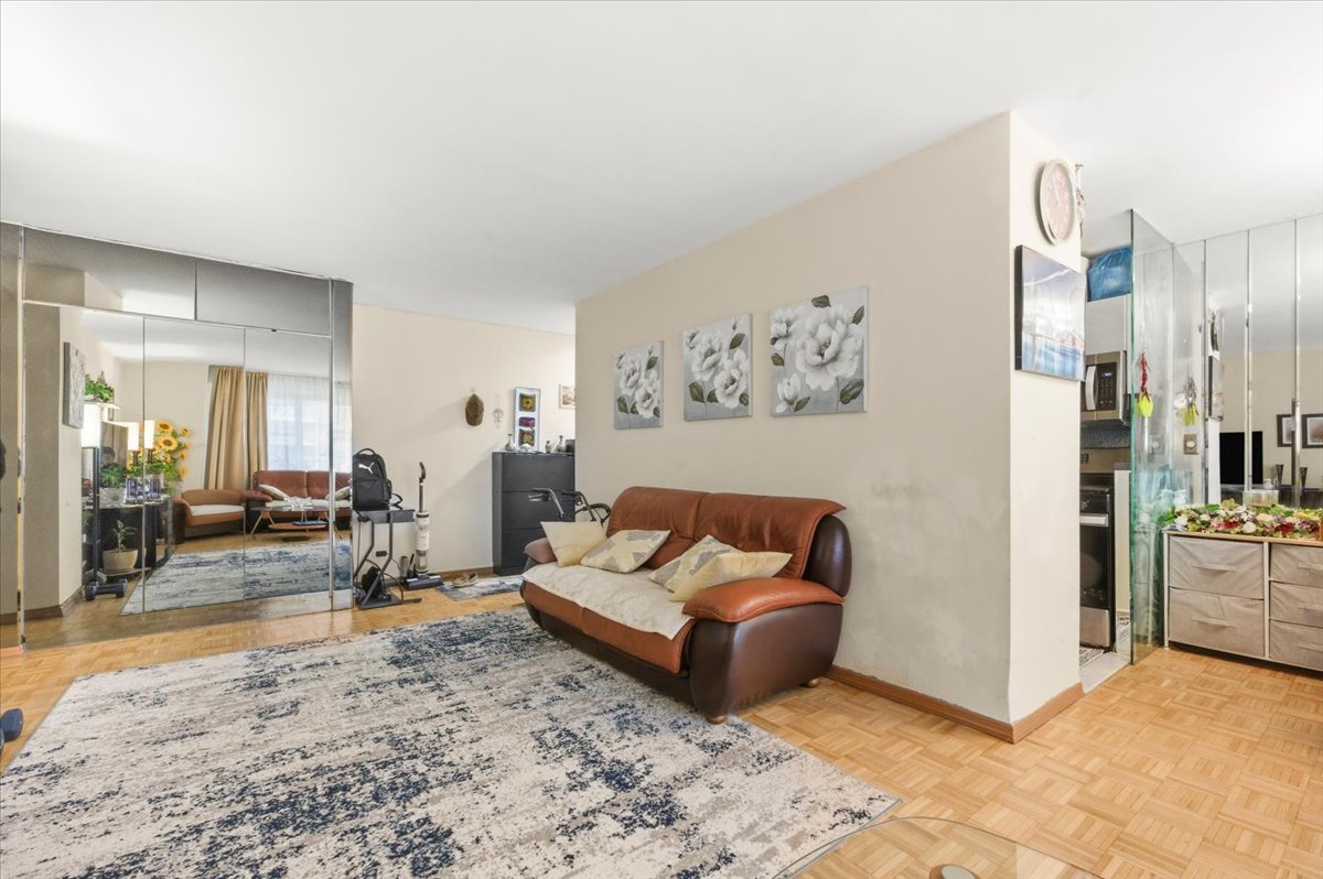 448 Neptune Avenue, Unit 14J Brooklyn, NY 11224 - Photo 2 of 21 a living room with furniture and a rug