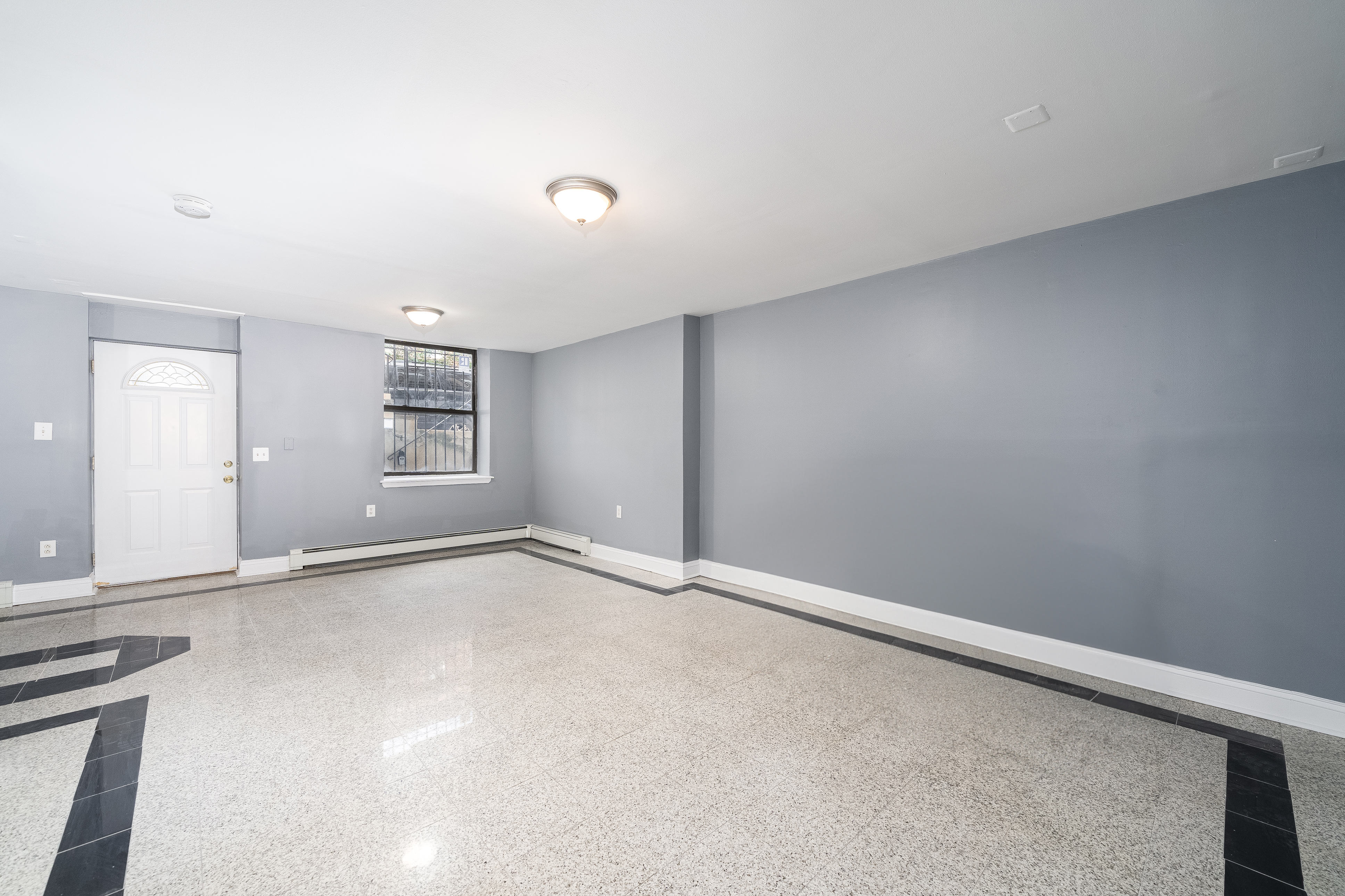 168 Coles Street, Unit BA Jersey City, NJ 07302 - Photo 10 of 29 an empty room with windows