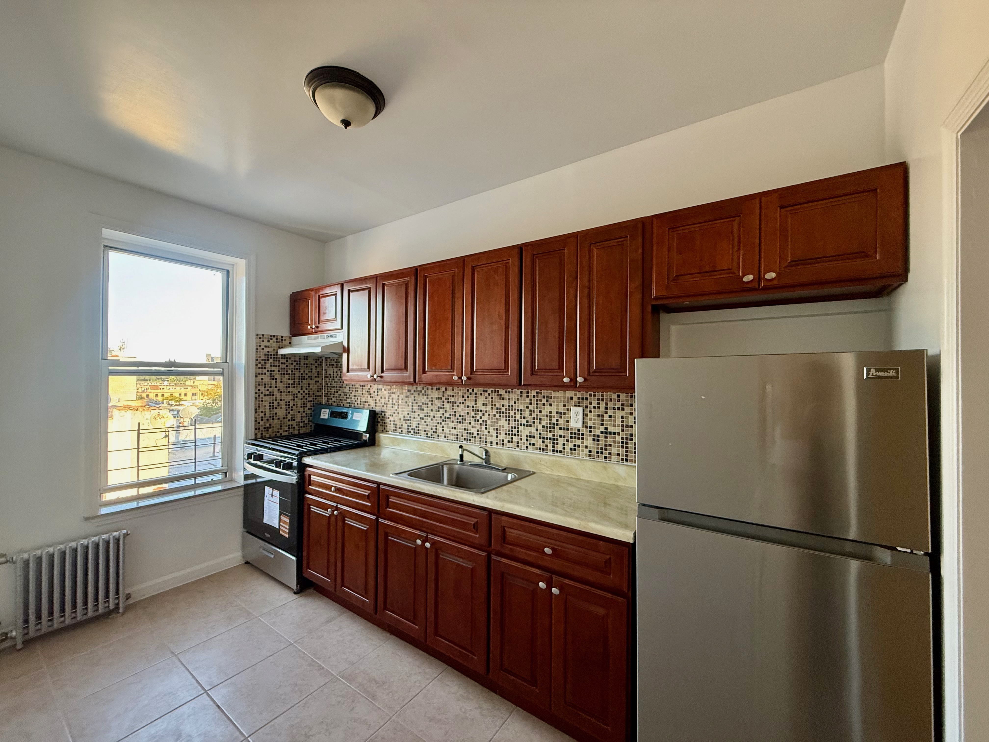 a kitchen with a refrigerator and a sink