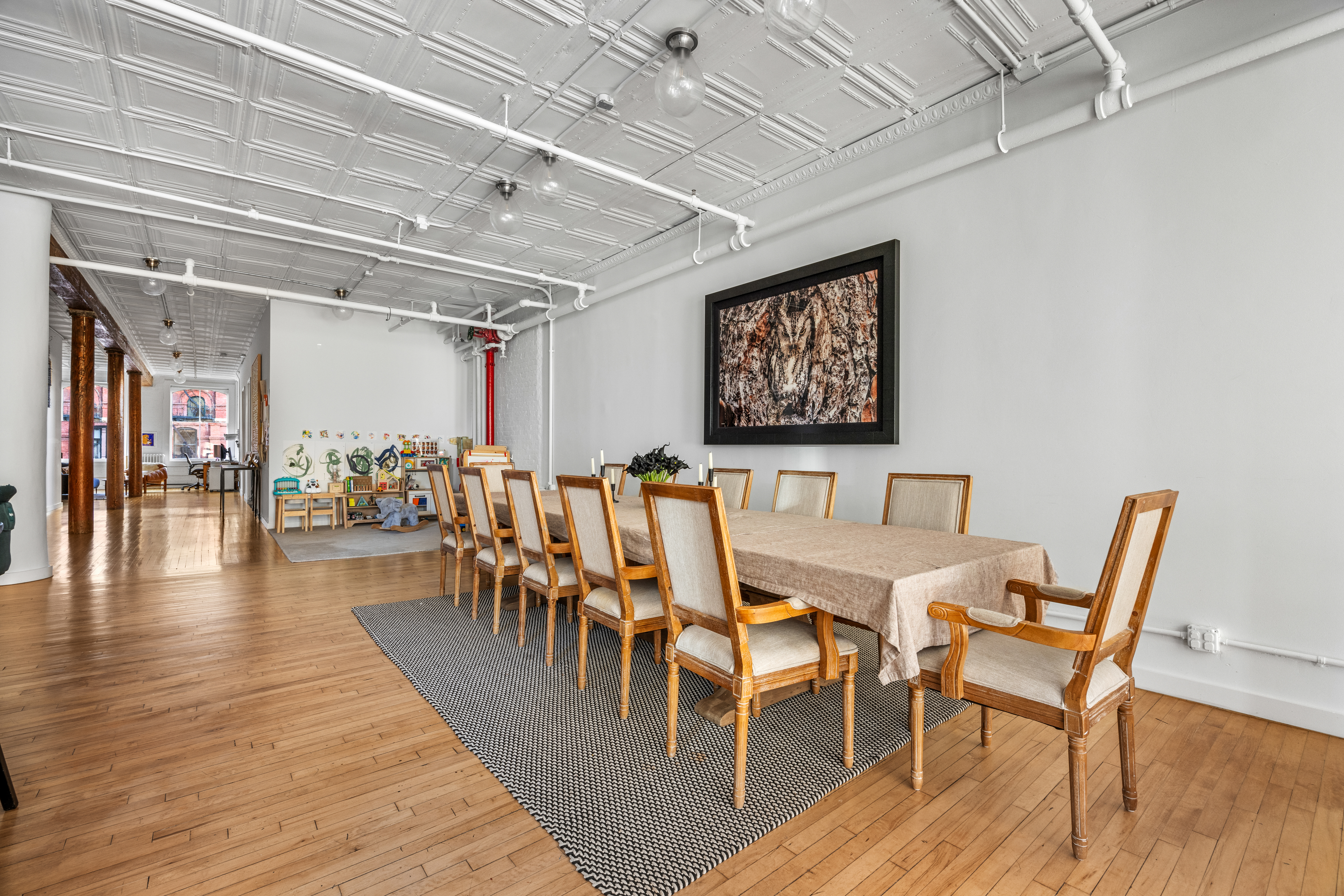5 White Street, Unit 5B Manhattan, NY 10013 - Photo 8 of 21 a dining room with furniture wooden floor a rug and a chandelier