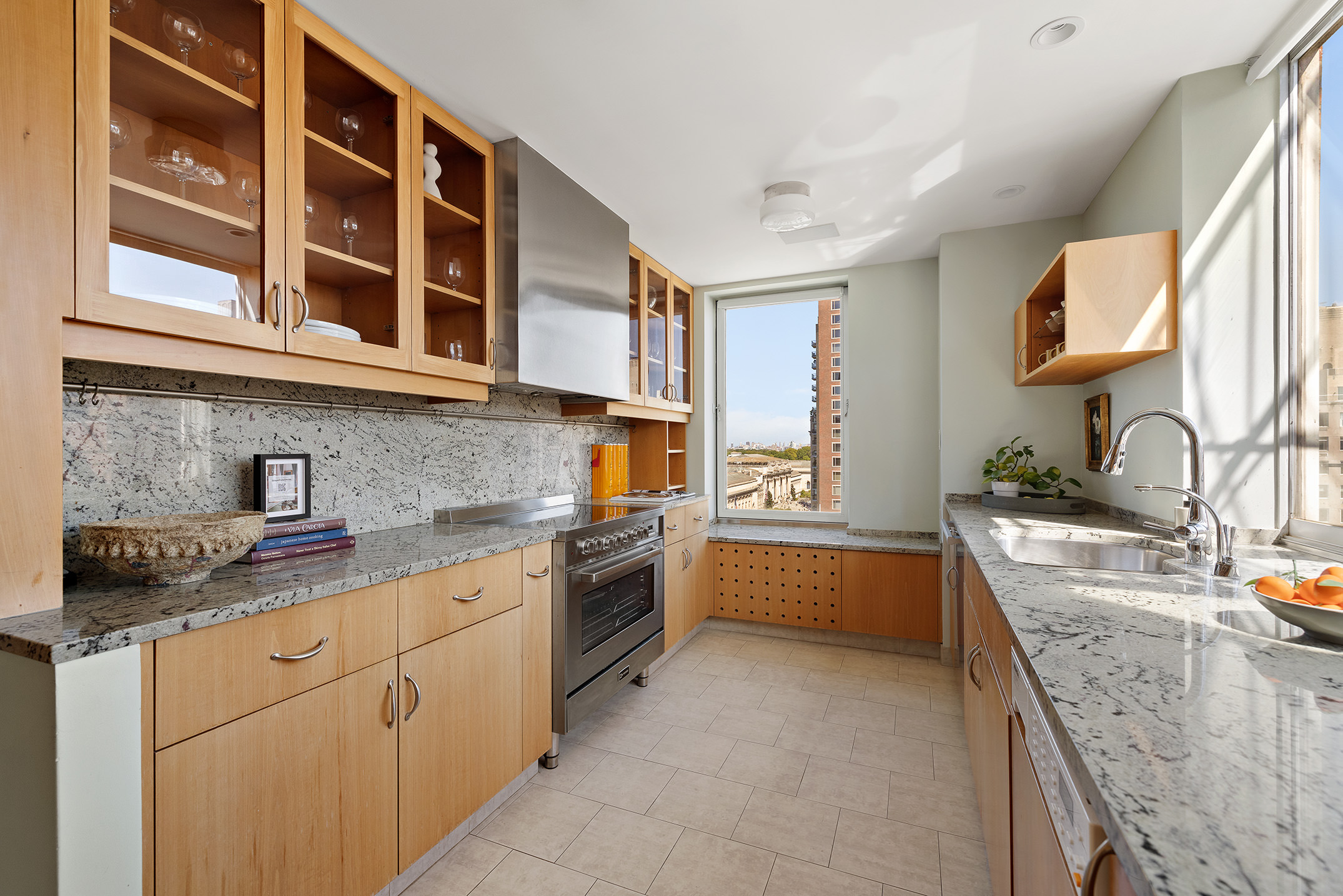 969 5th Avenue, Unit 14 Manhattan, NY 10075 - Photo 13 of 17 a kitchen with stainless steel appliances granite countertop a sink stove and cabinets