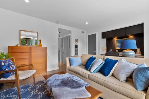 a living room with furniture and a lamp