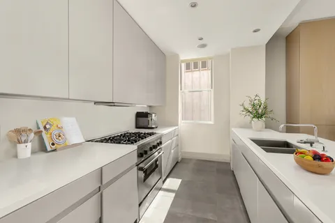 a kitchen that has a sink and a stove