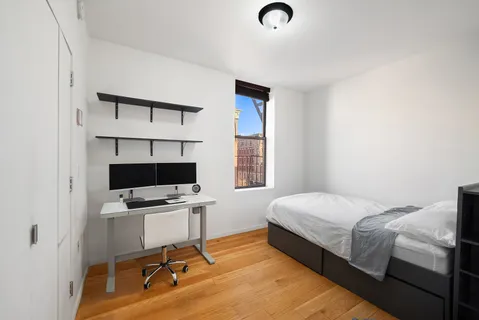 a bedroom with a workspace