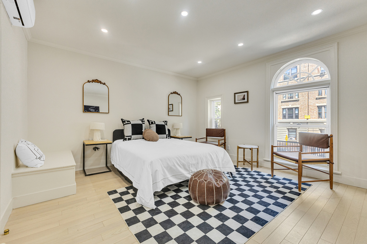 1050 Sterling Place Brooklyn, NY 11213 - Photo 7 of 23 a bedroom with a bed and wooden floor