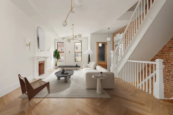 a living room with fireplace furniture and a chandelier
