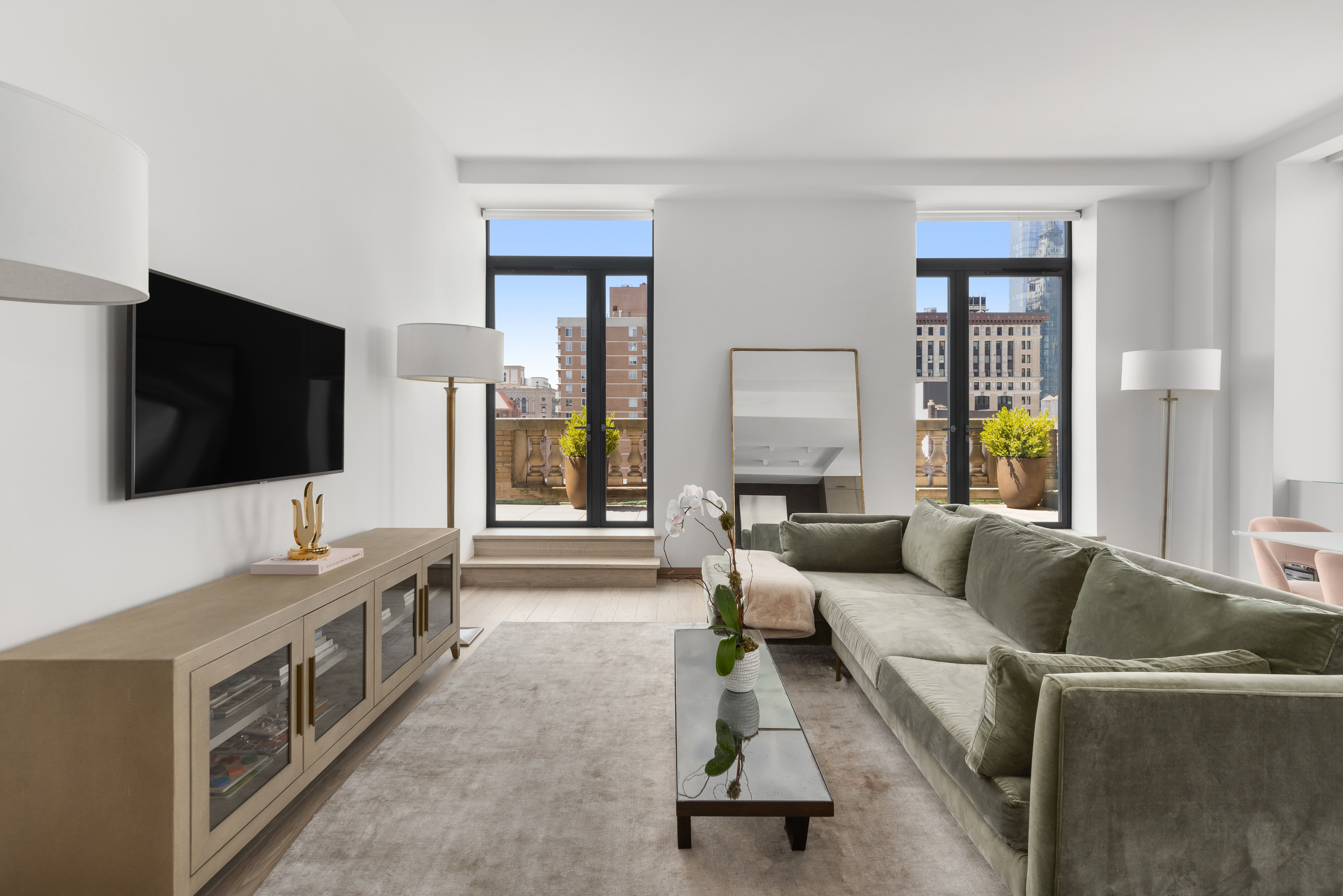 88 Lexington Avenue, Unit 1606 Manhattan, NY 10010 - Photo 5 of 20 a living room with furniture and a flat screen tv