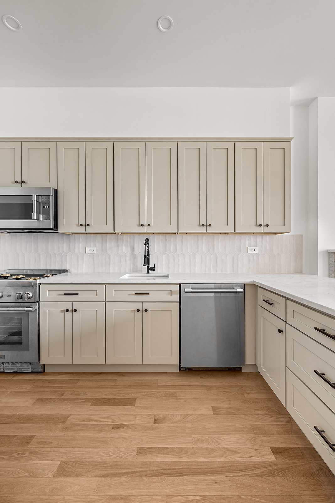 119 Henry Street, Unit 3 Brooklyn, NY 11201 - Photo 7 of 14 a kitchen with granite countertop white cabinets and stainless steel appliances