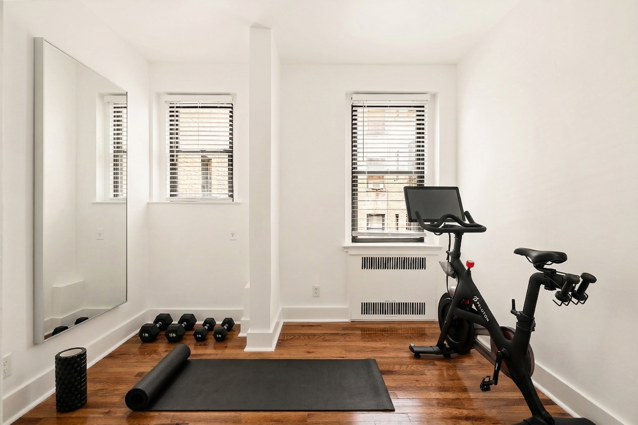 47-39 40th Street, Unit 1B Queens, NY 11104 - Photo 12 of 15 a room with gym equipment and a window