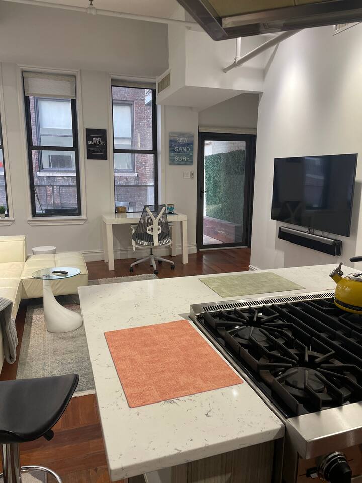 43-45 East 30th Street, Unit 8D Manhattan, NY 10016 - Photo 5 of 11 a living room with furniture and a flat screen tv