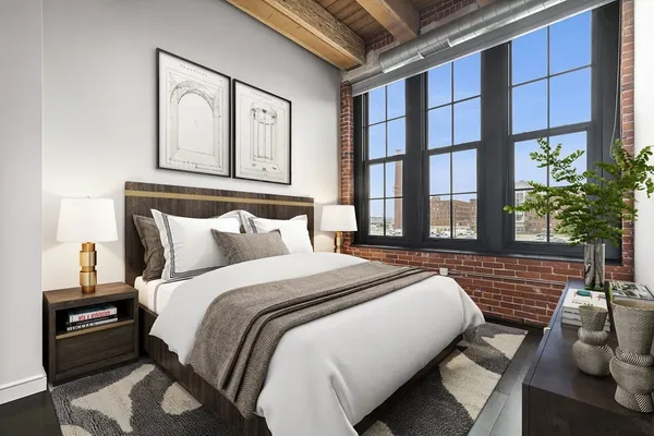 a bedroom with a bed and a potted plant