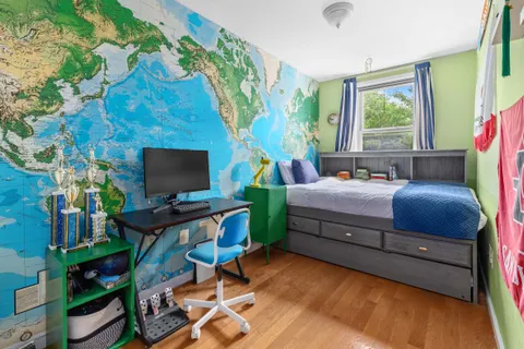 a bedroom with furniture and a flat screen tv