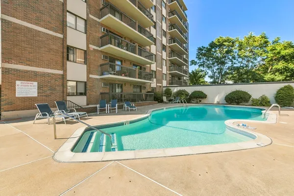 a view of a swimming pool with a patio