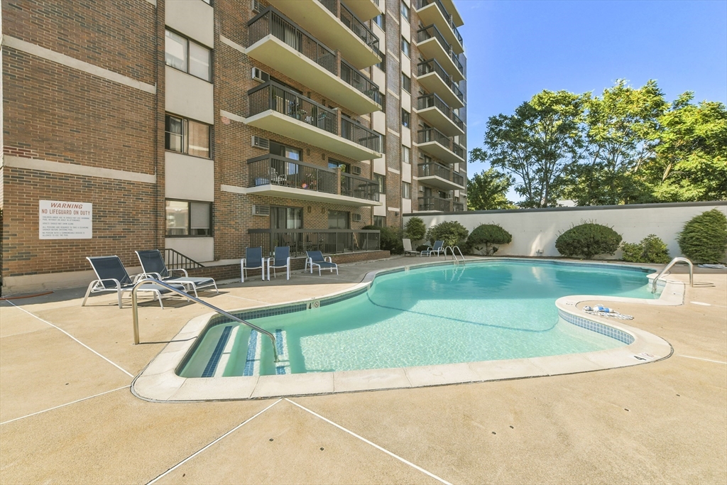 164 Galen Street, Unit 52 Watertown, MA 02472 - Photo 18 of 20 a view of a swimming pool with a patio