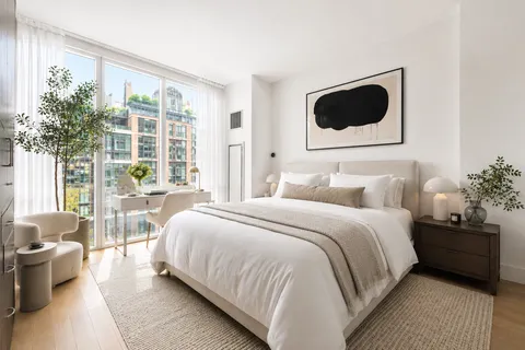 a bedroom with bed and window