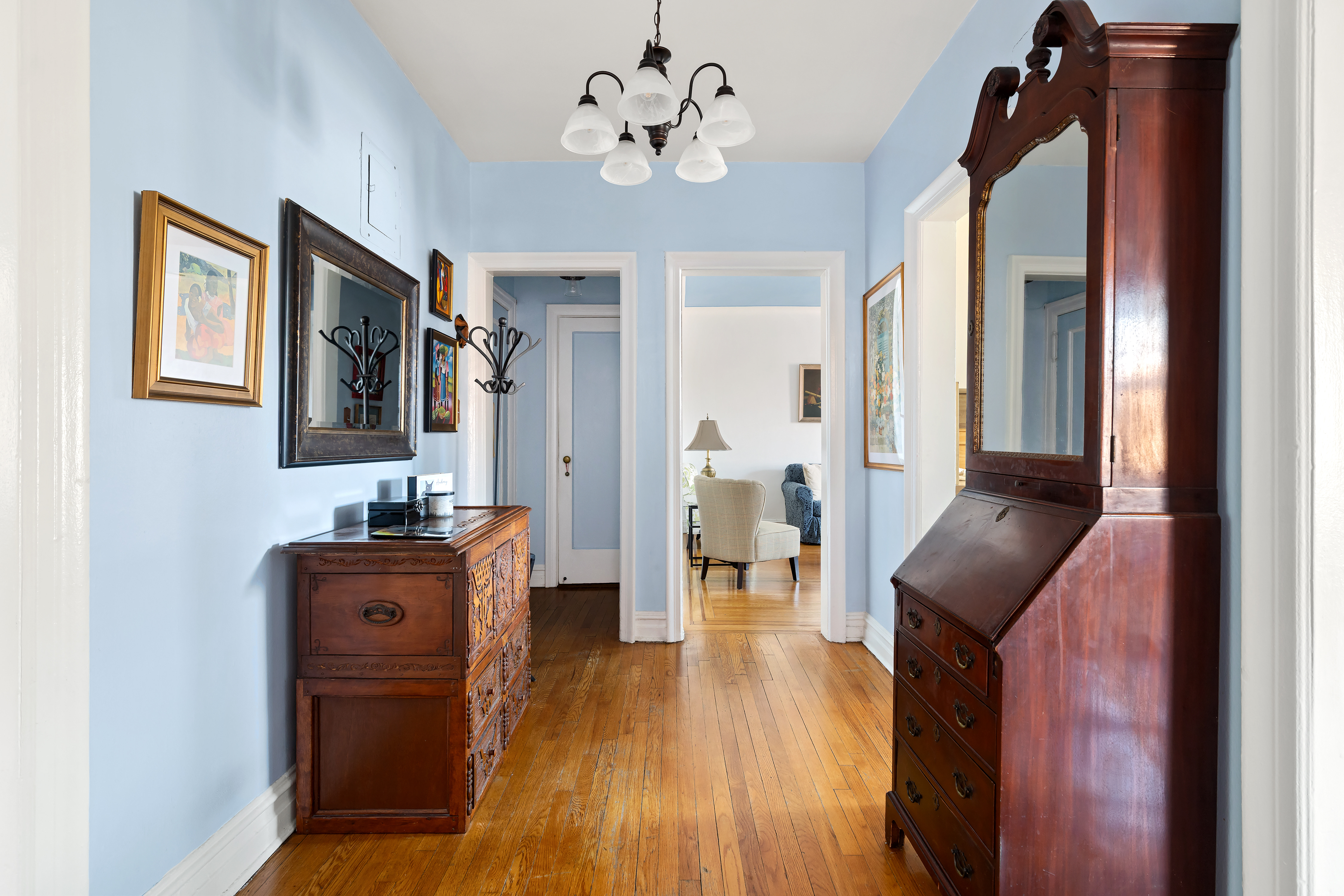 83-10 35th Avenue, Unit 5O Queens, NY 11372 - Photo 6 of 8 a hallway with furniture and wooden floor